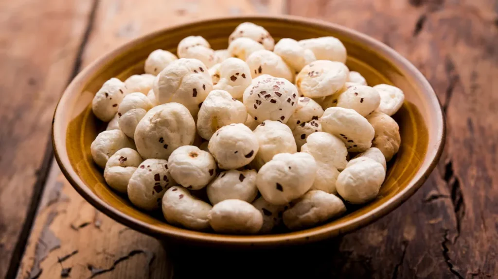 A close-up view of premium quality makhana (fox nuts) displayed in an elegant wooden bowl, highlighting the purity and texture of the product offered by an Indian export company.